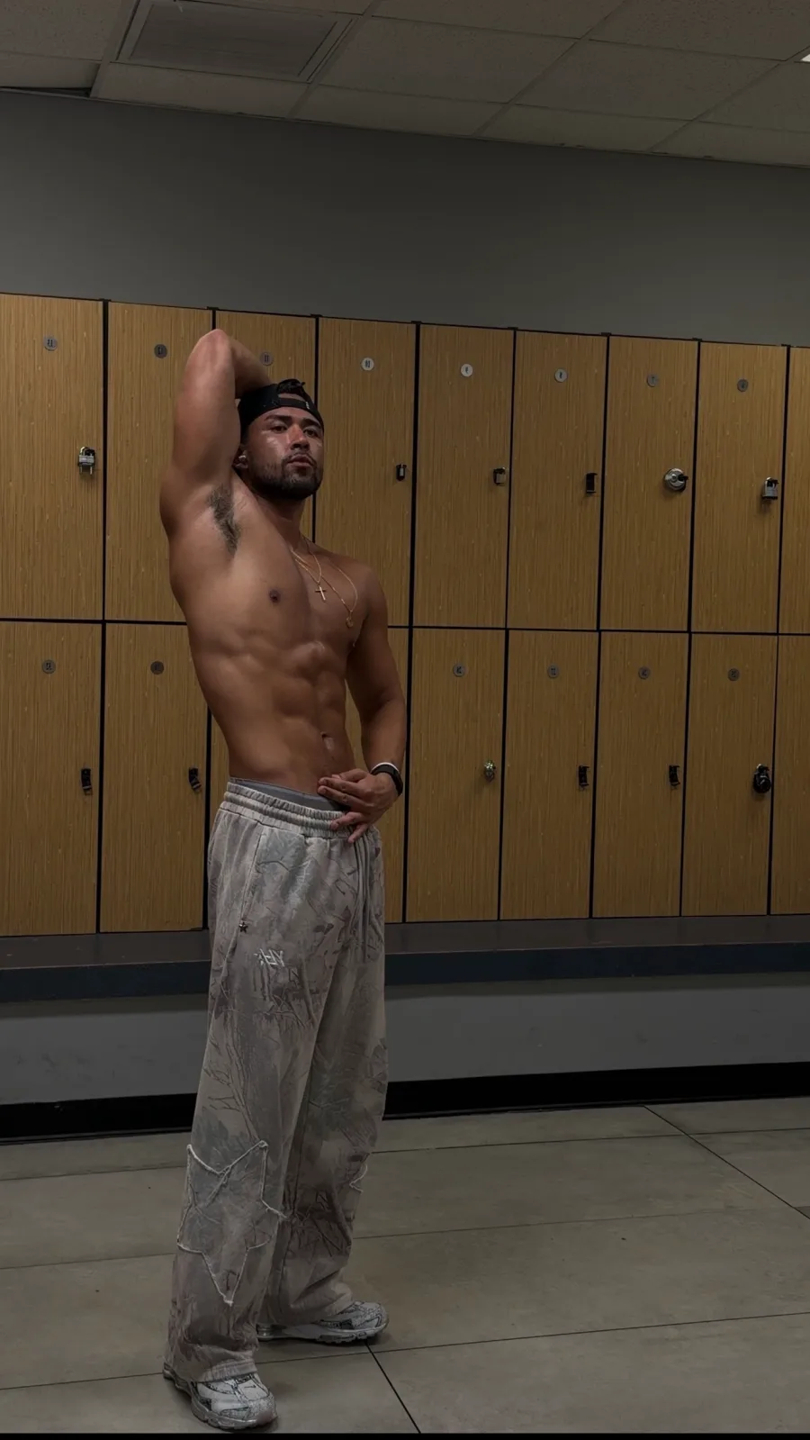 Jordan flexing in a gym locker room